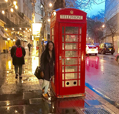 Thea Wilson in London Woman leaning against red telephone booth