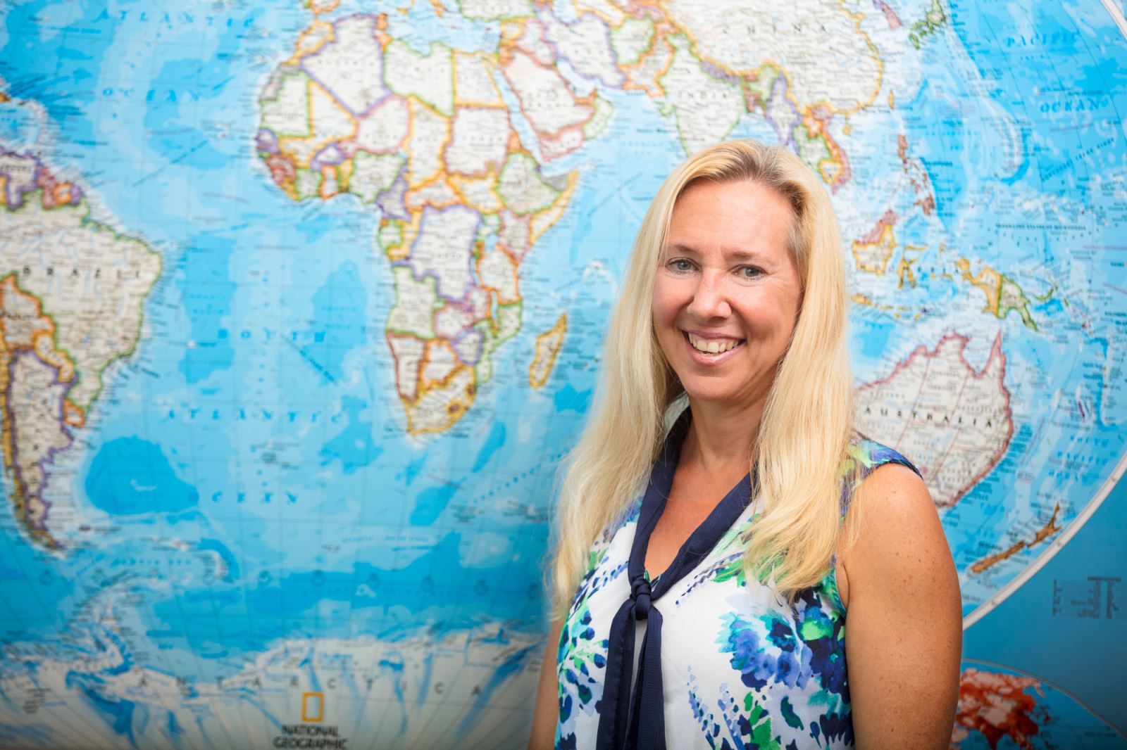 Woman standing in front of map of world