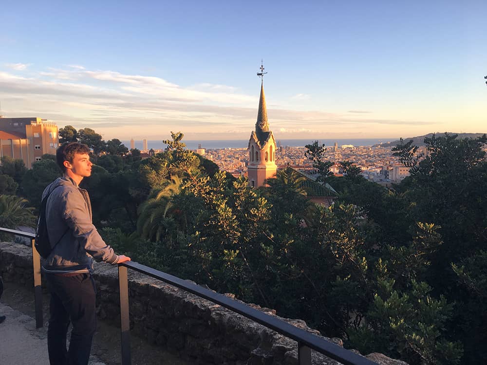 Male student takes in views of Barcelona, Spain