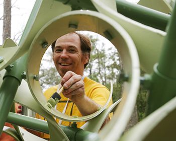 Man is painting a mathematical sculpture