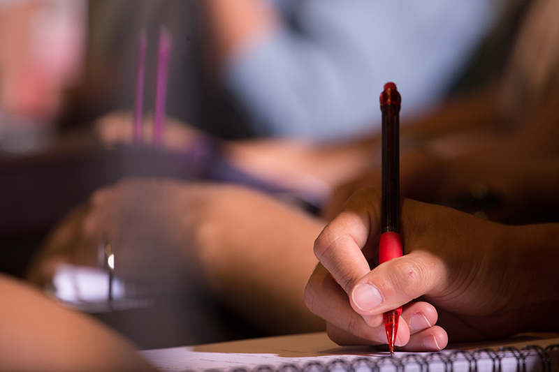 Student takes notes in class.