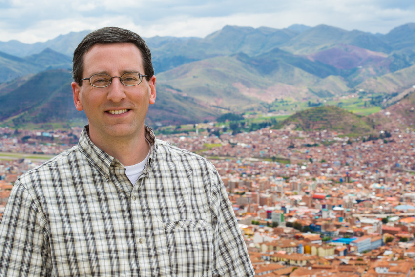 Man standing in front of view of Lima