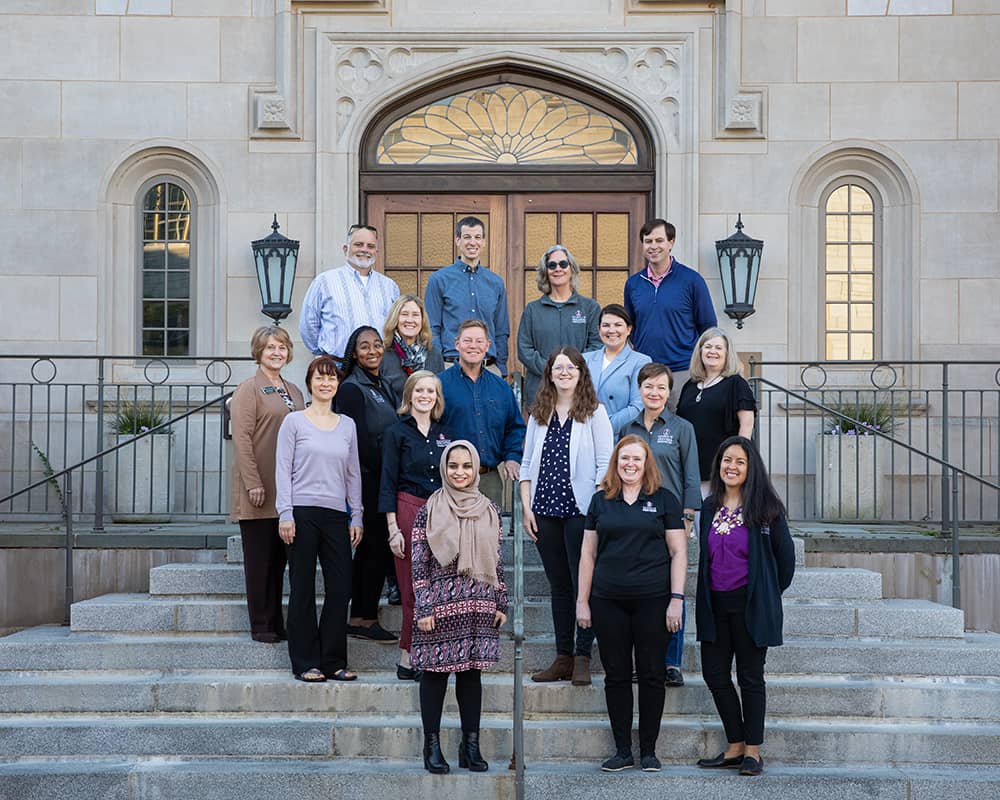 group shot of Honors College staff, on steps of Gearhart Hall