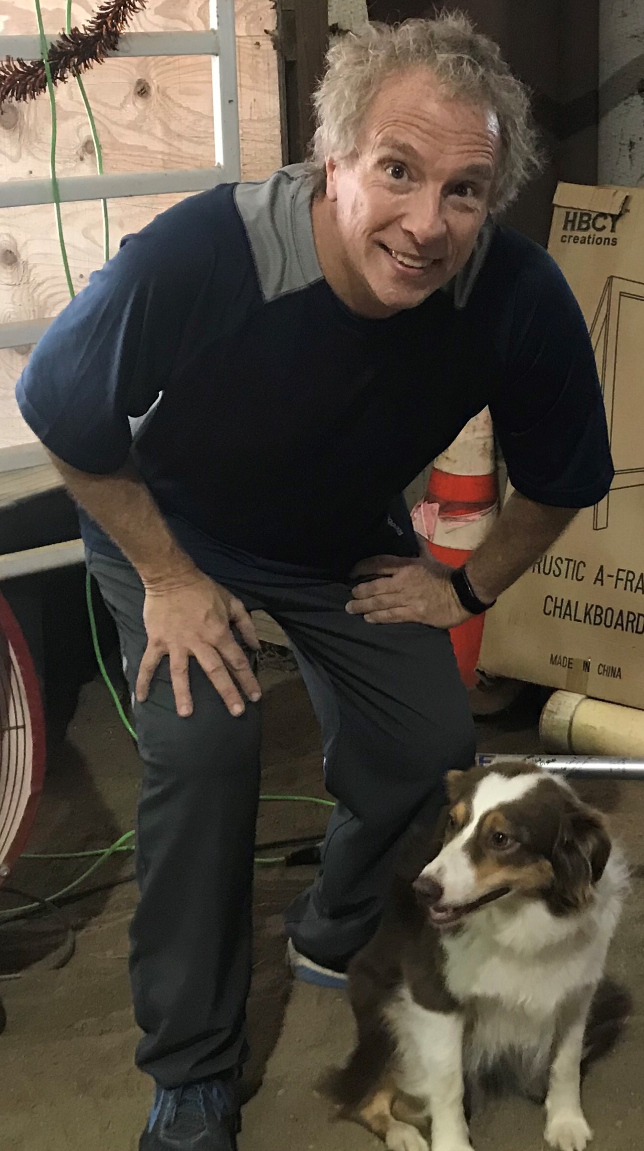 man poses with dog