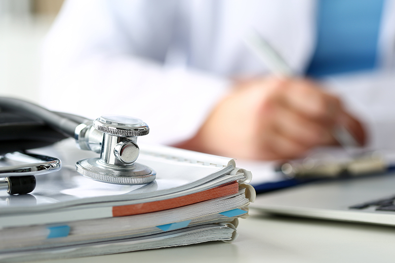 stethoscope rests on pile of books