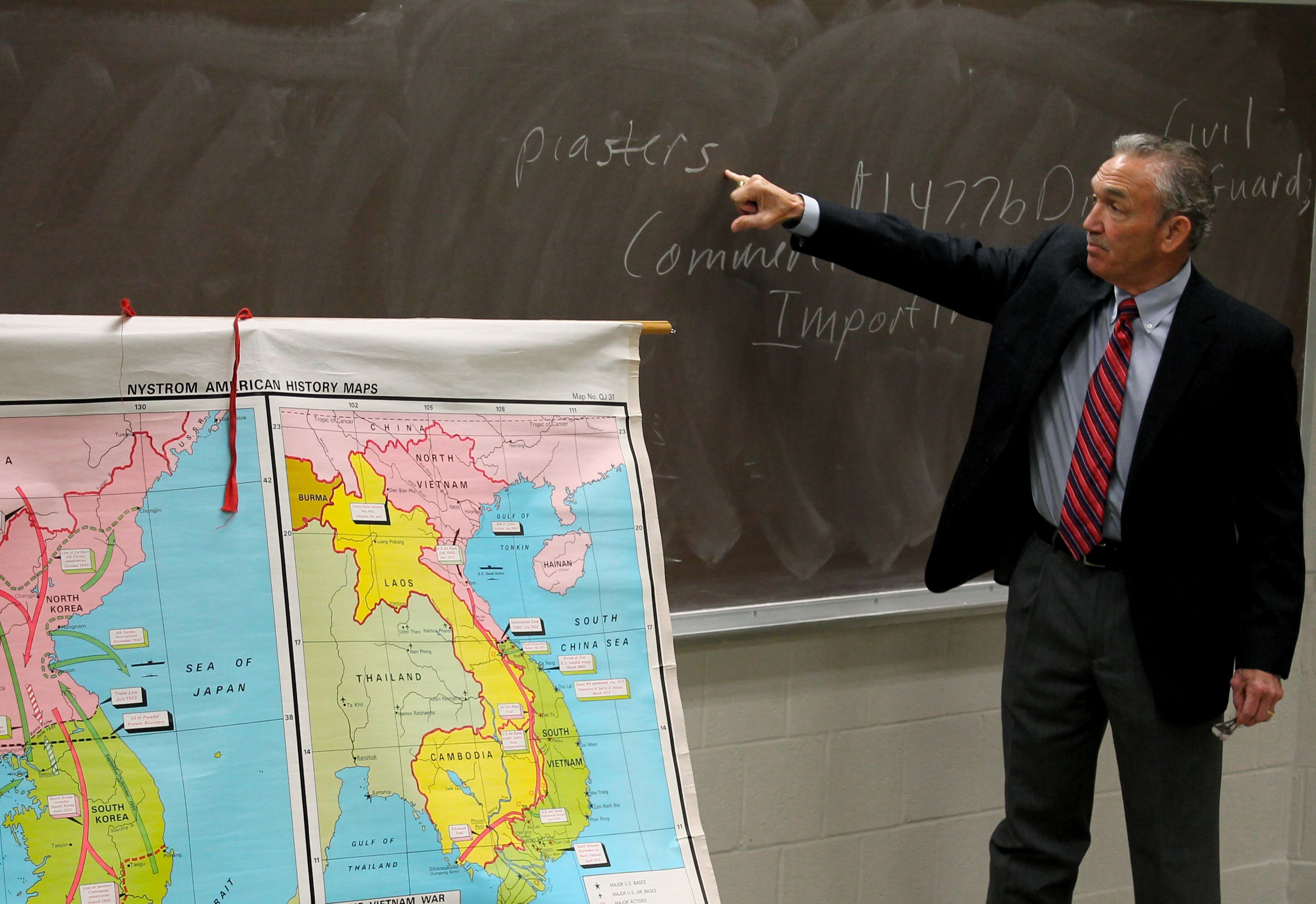 Man pointing to work on chalkboard