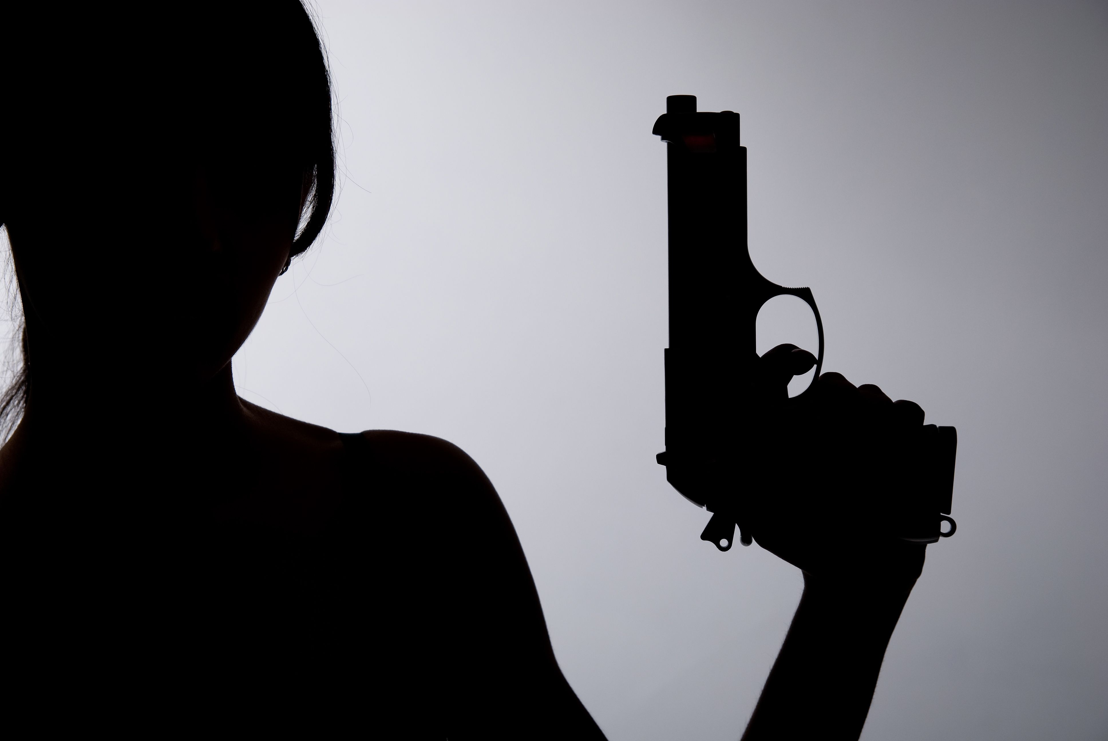 silhouette of woman with a gun