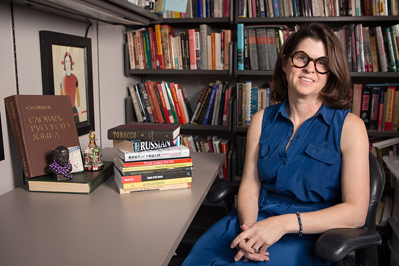 portrait of woman at desk with Russian history books