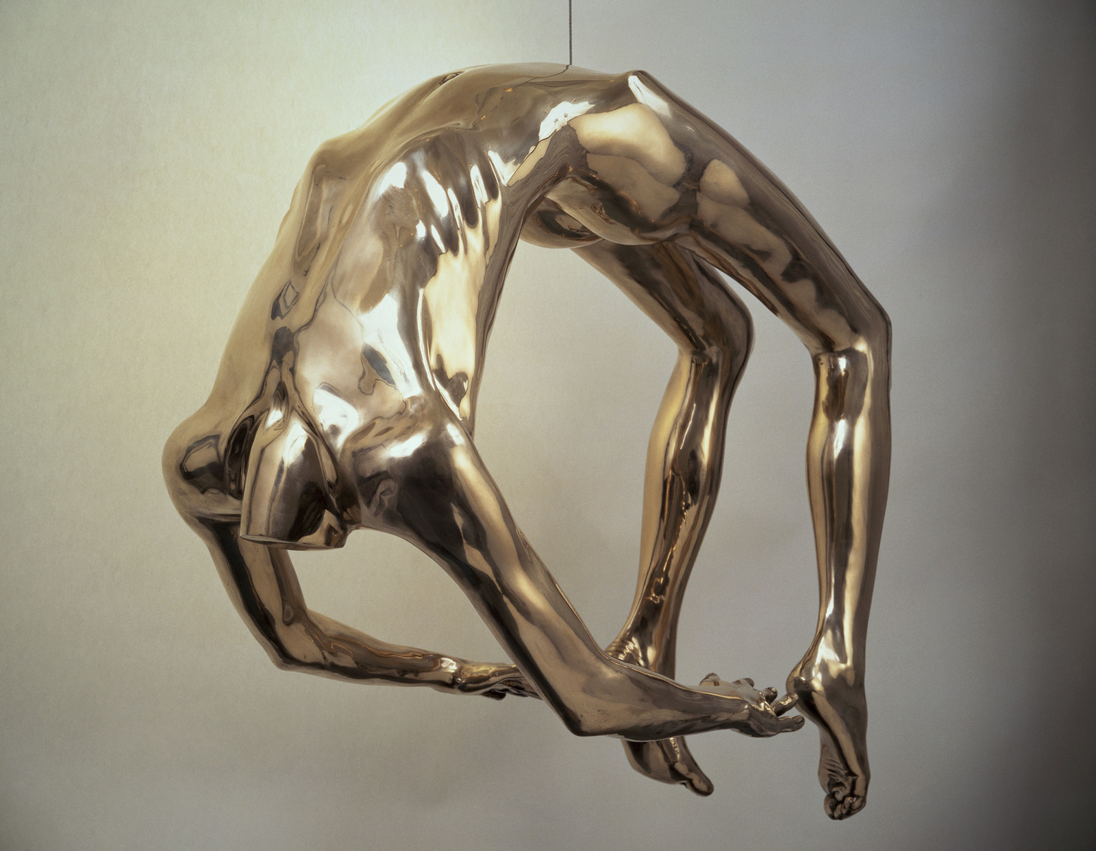 Bronze sculpture of a human body bent backwards